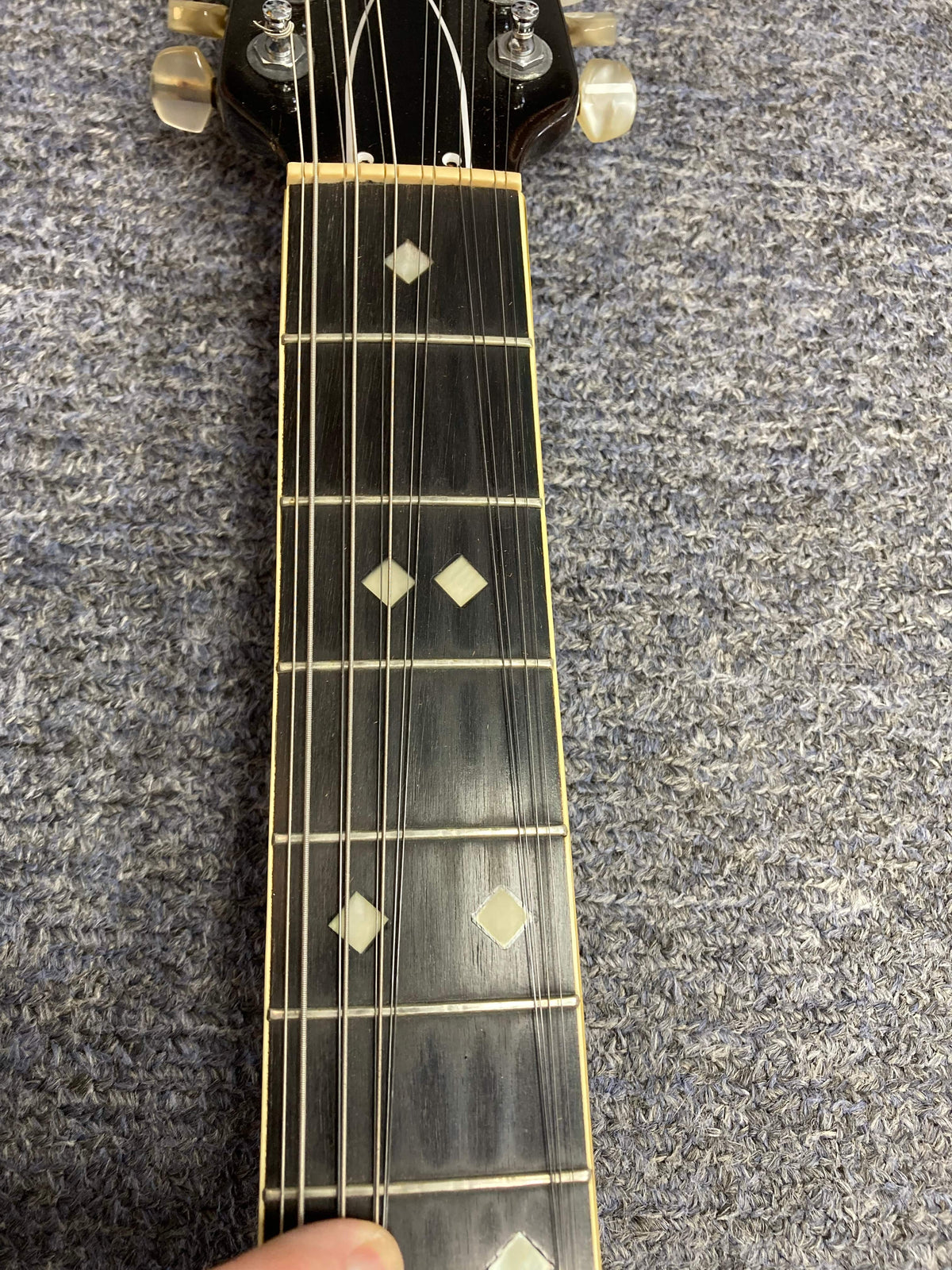 Ovation Deacon 12-String Electric Guitar Black with white diamond inlays on neck, solid body, minor headstock chip, and pickguard crack.