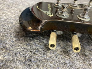 Close-up of the Ovation Deacon 12-String Electric Guitar, showcasing its solid body design and intricate detailing.