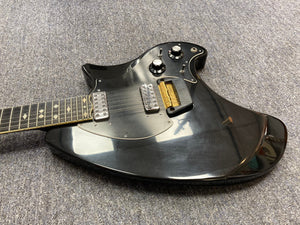 Ovation Deacon 12-String Electric Guitar in black, displayed on a grey carpet, highlighting its vintage solid body and distinctive knobs.
