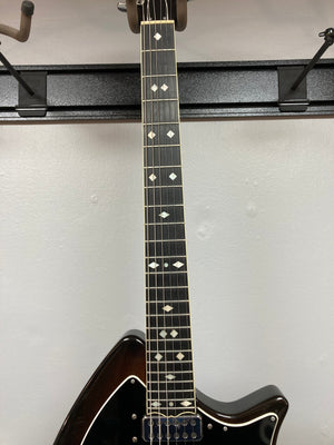 Ovation Deacon 1973-1975 - Sunburst Electric Guitar on a rack, showcasing its vintage sunburst finish and well-preserved condition.