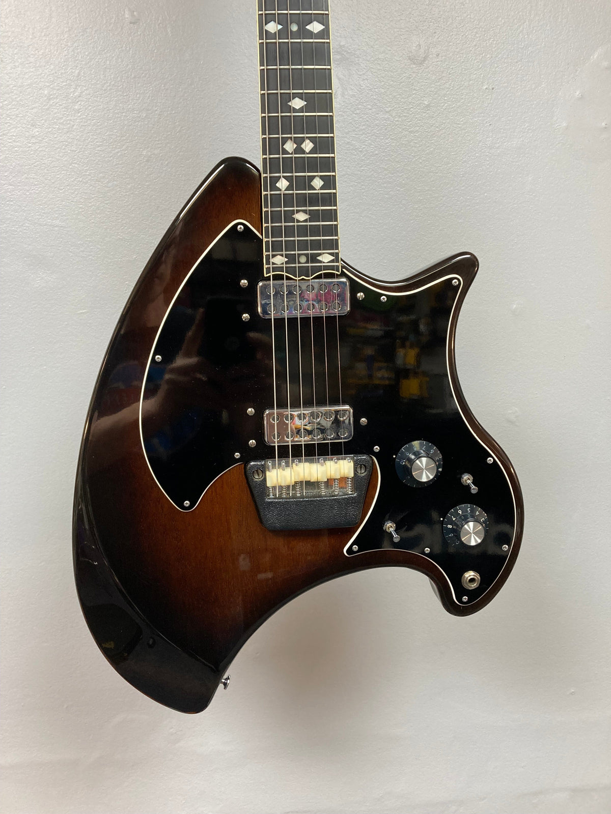 Ovation Deacon 1973-1975 Sunburst Electric Guitar showcasing its strings, dials, and well-preserved body, with a minor crack on the pickguard toggle switch.