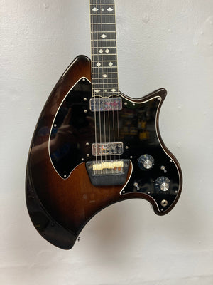 Ovation Deacon 1973-1975 Sunburst Electric Guitar showcasing its strings, dials, and well-preserved body, with a minor crack on the pickguard toggle switch.