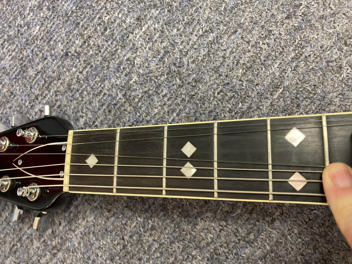 Ovation Deacon 1973-1975 Sunburst Electric Guitar on floor, highlighting vintage condition with minor wear and original case.