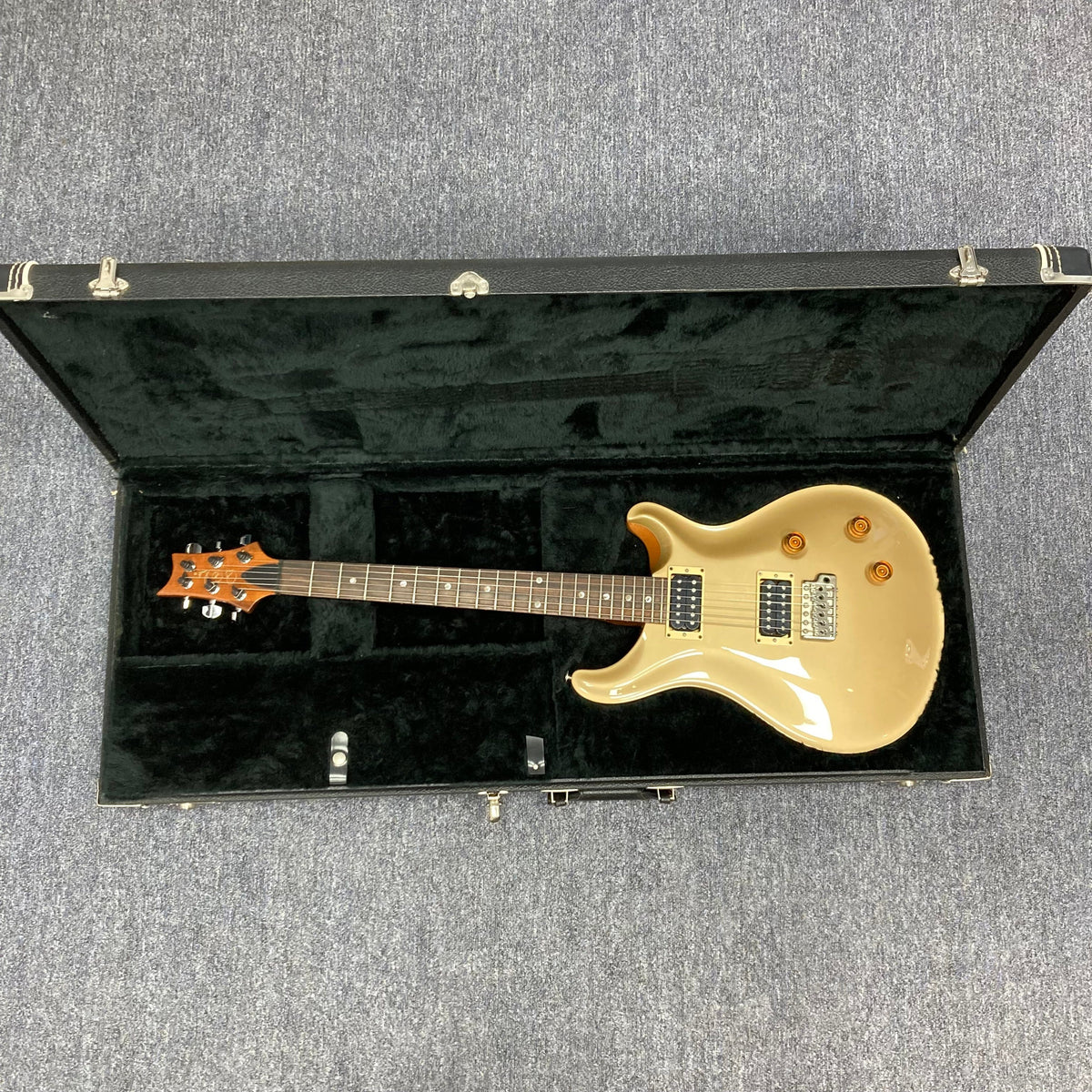 PRS 1996 Gold Top guitar in its original hard case, showcasing its lustrous finish and contoured neck, perfect for versatile tones and supreme playability.