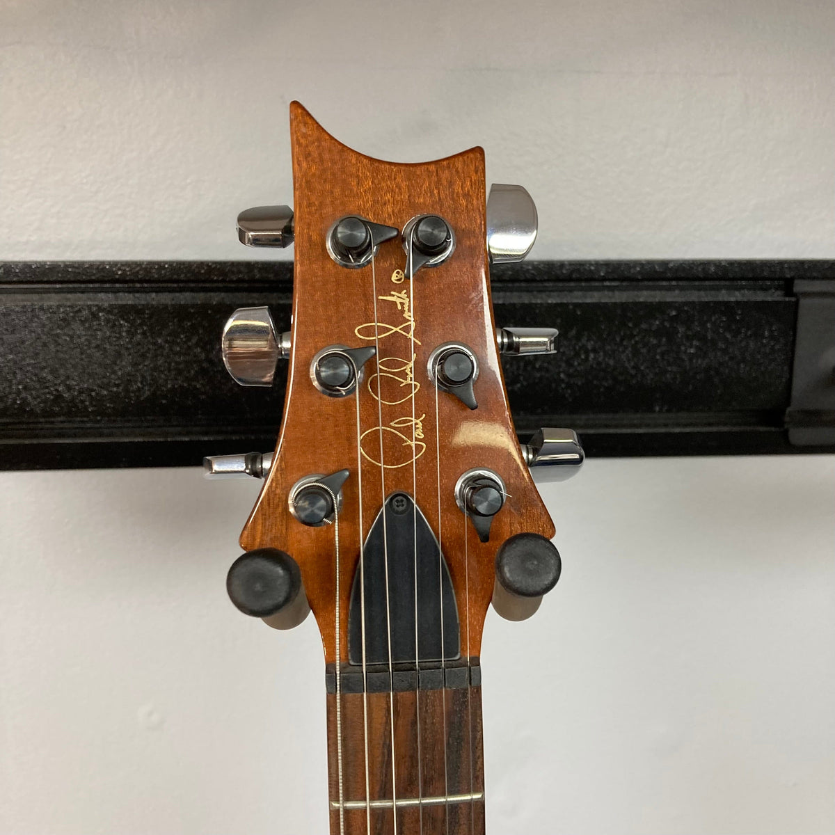 PRS 1996 Gold Top guitar headstock with tuning pegs, showcasing its vintage charm and meticulous craftsmanship.