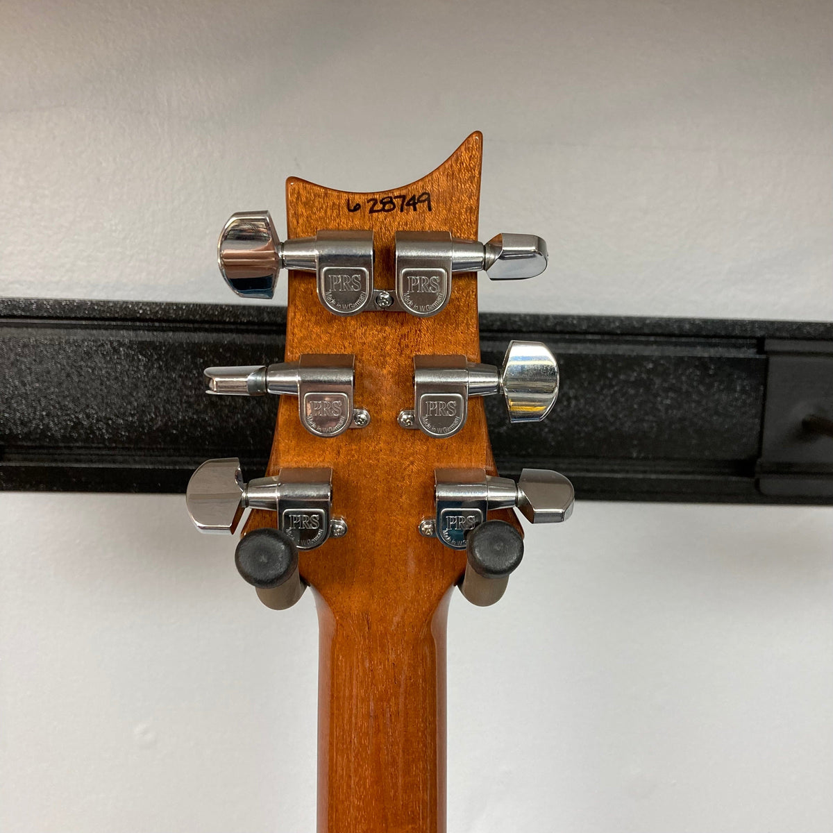 PRS 1996 Gold Top guitar close-up, showcasing its lustrous finish and original hard case for protection.