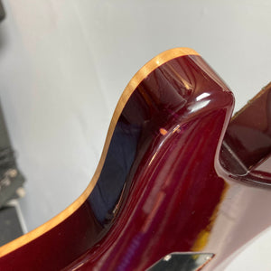 Close-up of the upper horn of a glossy red PRS Custom 24 Angry Larry 2011 electric guitar by PRS, highlighting the wood grain along the edge and its smooth, curved contour, set against a neutral background.