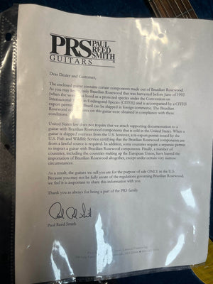 A letter from PRS explains the use of Brazilian Rosewood in guitars like the PRS P22 Artisan Piezo Green Fade 2013 and outlines legal restrictions on its distribution and sale in the U.S.