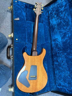 PRS P22 Artisan Piezo Green Fade 2013 electric guitar by PRS, with Brazilian Rosewood, shown from the back highlighting wood grain and gold hardware. Comes in a blue velvet-lined hard case; partial view of a person's knee on the left.