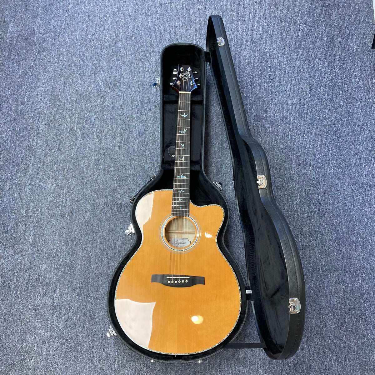 PRS SE A50E Charcoal Burst acoustic guitar in a fitted case, showcasing its maple back and sides, spruce top, and iconic PRS bird inlays.