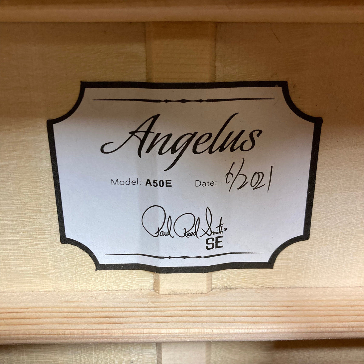 PRS SE A50E Charcoal Burst w/Case Used, featuring a close-up of the label and black handwritten text. Ideal for live performances with Fishman GT1 pickup system.