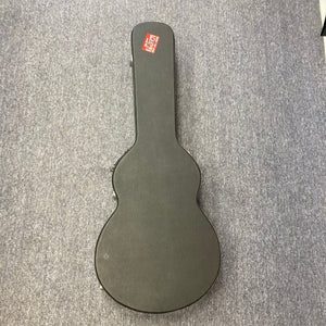 PRS SE A50E Charcoal Burst acoustic guitar in a black case on a carpet, featuring a maple back, spruce top, and Fishman GT1 pickup system.