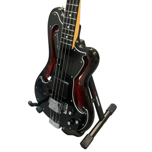 A Rare Ampeg AEB-2 Scroll Top Bass, Serial #13 and a prototype-era Bruce Johnson build, is displayed on a stand against a white background, highlighting its unique collectible appeal.