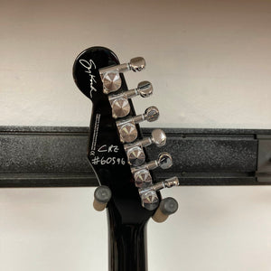 Close-up of the back of a Reverend Greg Koch Signature Gristle 90 headstock in 3-Tone Burst, showing six tuning pegs, a signature, and the markings "CR2 #60596" in white.