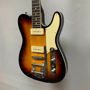 Reverend Greg Koch Signature Gristle 90 electric guitar in 3-Tone Burst with cream pickguard, Fishman Gristle 90 pickups, control knobs, Bigsby-style tremolo, and includes a gigbag.