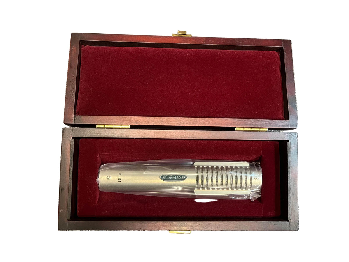A pre-owned Royer Labs R-121 Ribbon Microphone in excellent condition sits in a red velvet-lined wooden box with an open lid, perfect for your next studio recording session.