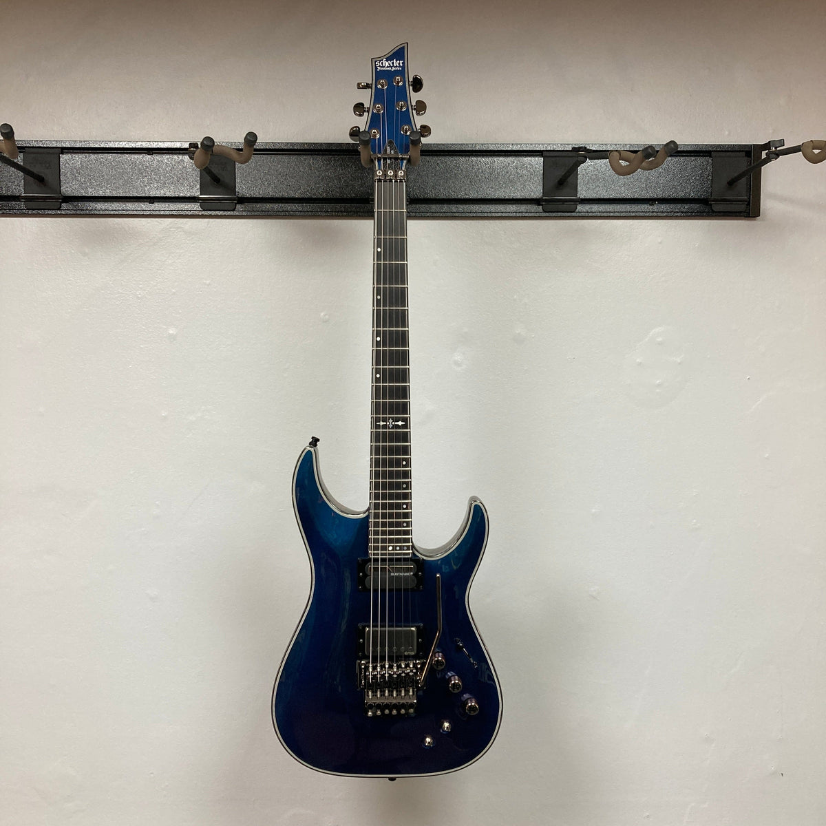 Schecter Hellraiser Hybrid C-1 FR S Sustainiac Ultra Violet Used, a blue electric guitar with prominent neck and pickups, displayed against a plain backdrop.