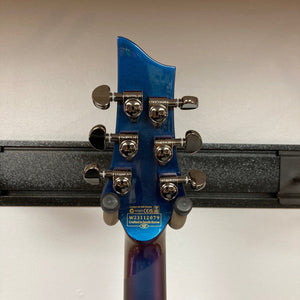 Schecter Hellraiser Hybrid C-1 FR S Sustainiac guitar featuring silver knobs and black chrome hardware, showcasing its Ultra Violet finish.