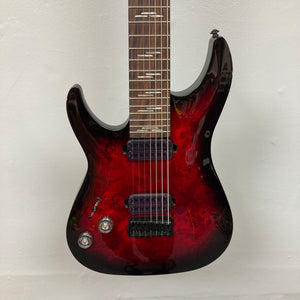 Schecter Omen Elite-7 Left-handed Black Cherry Burst Blemish, 7-string electric guitar with burl top and Heretic pickups, shown close-up.