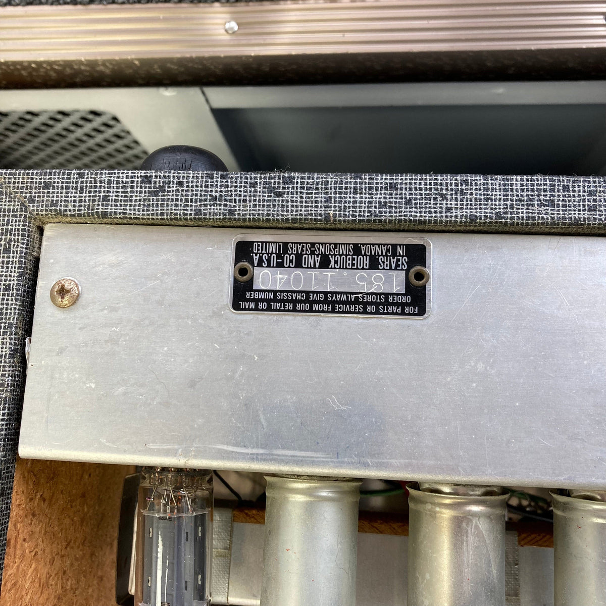 Silvertone Model 1484 Twin Twelve 60-Watt 2x12 Guitar Amp with metal housing, tubes, and black label, showcasing vintage design and powerful performance.