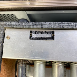 Silvertone Model 1484 Twin Twelve 60-Watt 2x12 Guitar Amp with metal housing, tubes, and black label, showcasing vintage design and powerful performance.