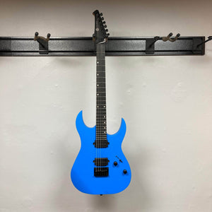 Spira S-400 MBL Electric Guitar with double-cutaway design, two humbucking pickups, fixed bridge, and black control knobs, hanging on a wall-mounted rack.