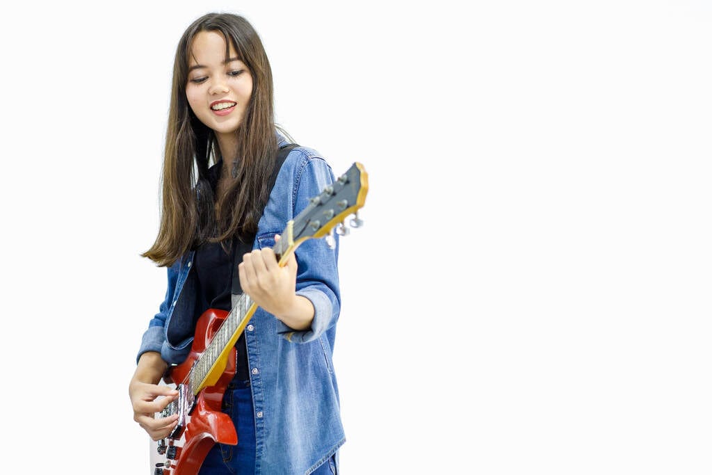 smiling young lady playing guitar smiling young lady playing guitar
