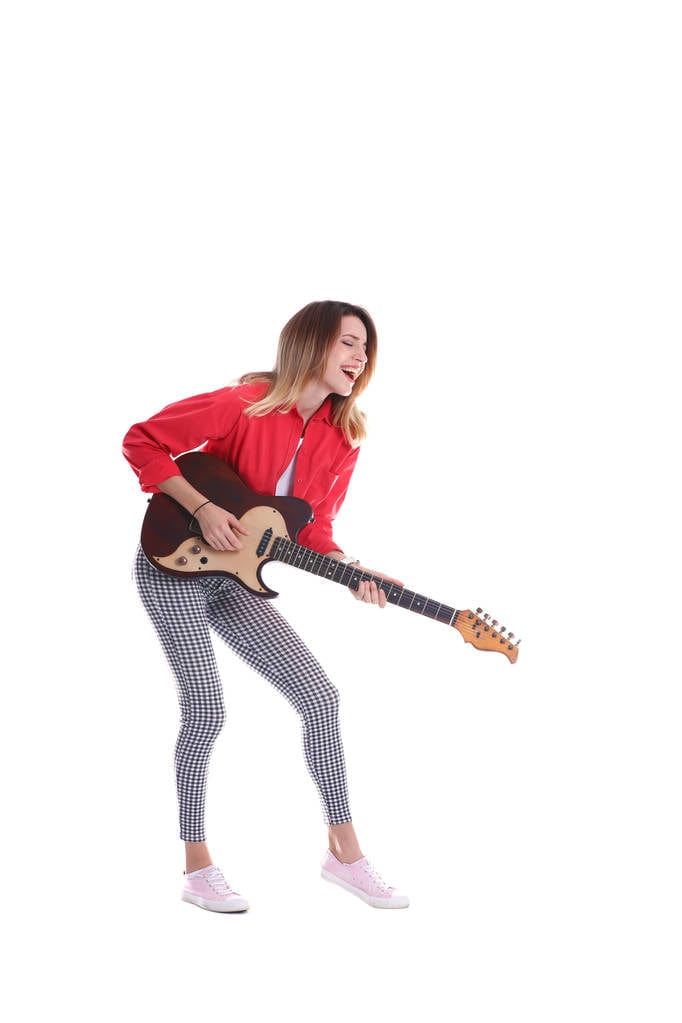 A young woman playing an electric guitar. A young woman playing an electric guitar.