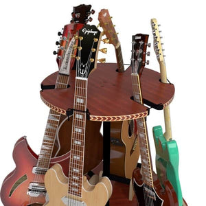 The Carousel™ Deluxe Rotating Guitar Stand by A&S Crafted Products securely holds several electric and acoustic guitars upright, offering a stylish and space-saving way to display different colors and brands.