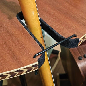 A close-up of The Carousel™ Deluxe Rotating Guitar Stand | Expansion Tier by A&S Crafted Products, featuring padded wooden supports joined by a black metal rod—perfect for secure vertical guitar rack setups.