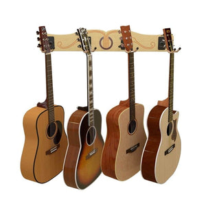 Four acoustic guitars in assorted finishes hang on the A&S Crafted Products Pro-File™ Wall-Mounted Guitar Hanger, creating a stylish wall display against a decorative wooden backdrop.
