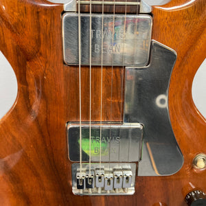 Close-up of the Travis Bean TB1000A guitar strings, highlighting the aluminum neck and original pickups.