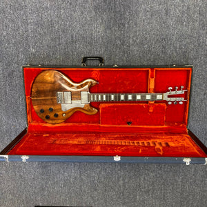 Travis Bean TB1000A Artist Natural 1970s in a vintage red case, showcasing its aluminum neck and original components.