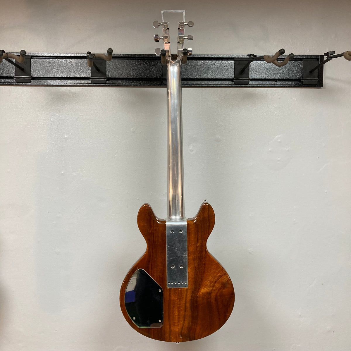 Travis Bean TB1000A Artist Natural 1970s guitar with aluminum neck and original pickups, mounted on a wall.