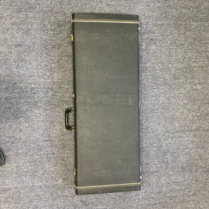 Travis Bean TB1000A Artist Natural 1970s guitar in a black vintage case with gold handles on grey carpet.