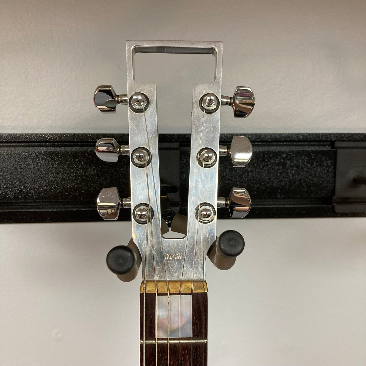 Close-up of Travis Bean TB1000A Artist Natural guitar from the 1970s, showcasing multiple metal knobs and original components.