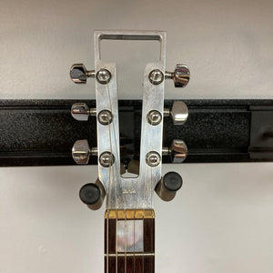 Close-up of Travis Bean TB1000A Artist Natural guitar from the 1970s, showcasing multiple metal knobs and original components.