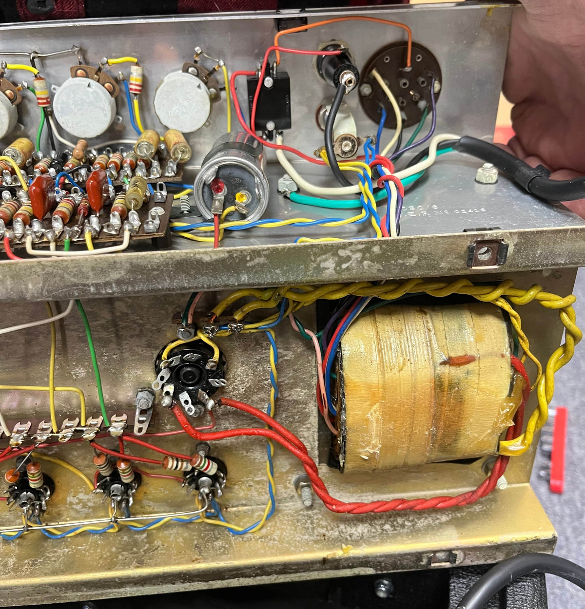 Close-up of electronic components and wiring inside a Vintage 1963 Vox AC30/6 Normal by Vox, showing circuit boards, capacitors, a Woden transformer, and wiring—similar to what’s found in the original JMI Egg Footswitch-equipped models.