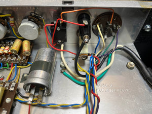 Close-up of electronic components and wiring inside a Vintage 1963 Vox AC30/6 Normal by Vox, featuring original JMI egg footswitch and flight case, with classic resistors, capacitors, and colored wires typical of vintage amplifiers.