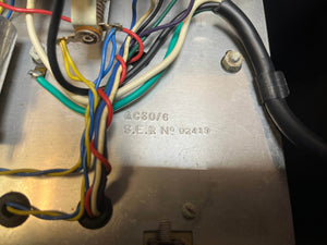 Close-up of colored wires on a metal surface stamped "AC30/6 S.E.R No 02419," showcasing components of the Vintage 1963 Vox AC30/6 Normal with Original JMI Egg Footswitch and Flight Case by Vox.
