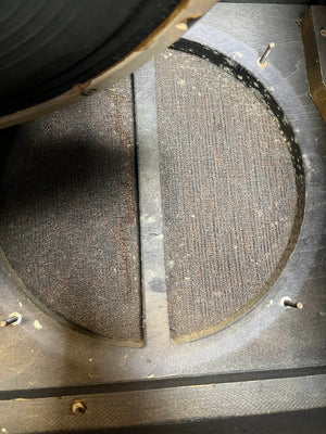 Close-up of an empty speaker cabinet with circular opening and fabric back panel—ideal for a Celestion Blue T530, just like those in the Vintage 1963 Vox AC30/6 Normal by Vox, complete with original JMI egg footswitch and flight case.