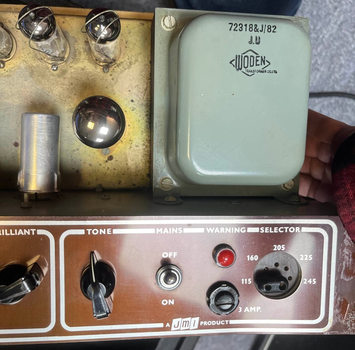 Close-up of a Vintage 1963 Vox AC30/6 Normal by Vox, featuring knobs, a voltage selector, glass tubes, a Woden transformer, and includes its original JMI egg footswitch and flight case.