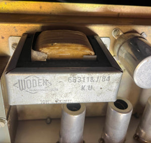 Close-up of a Woden transformer labeled "66311&J/84 K.U" inside a Vox Vintage 1963 AC30/6 Normal amp, with visible coils and metal parts—similar components are found in classic models with JMI egg footswitches and flight cases.