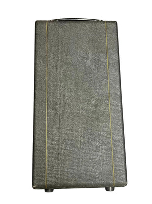 A rectangular, textured dark gray Vox flight case with two vertical yellow lines and a black top handle, inspired by the classic 1963 Vox AC30/6 Normal design, shown from the front.