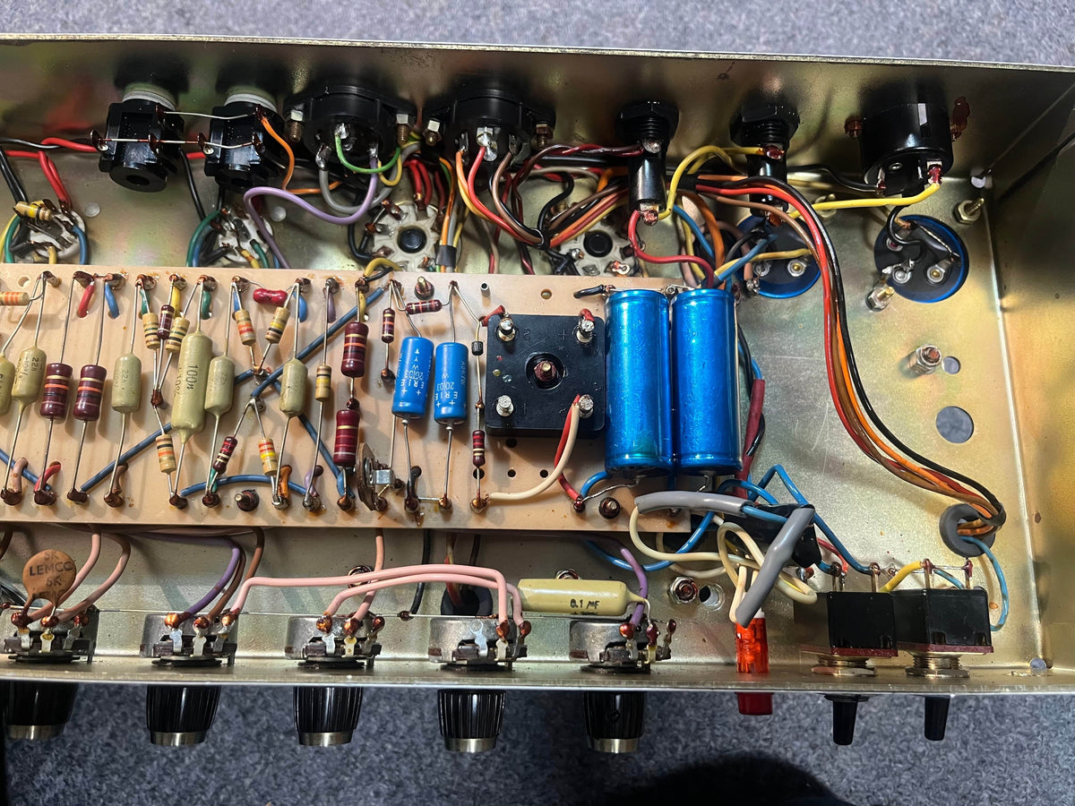 Interior view of a 1971 Marshall Lead Head JMP 1987 50 Watt amp by Marshall, showing resistors, capacitors, wiring, and circuits on a metal chassis—ideal for classic British Grind. Includes flight case.
