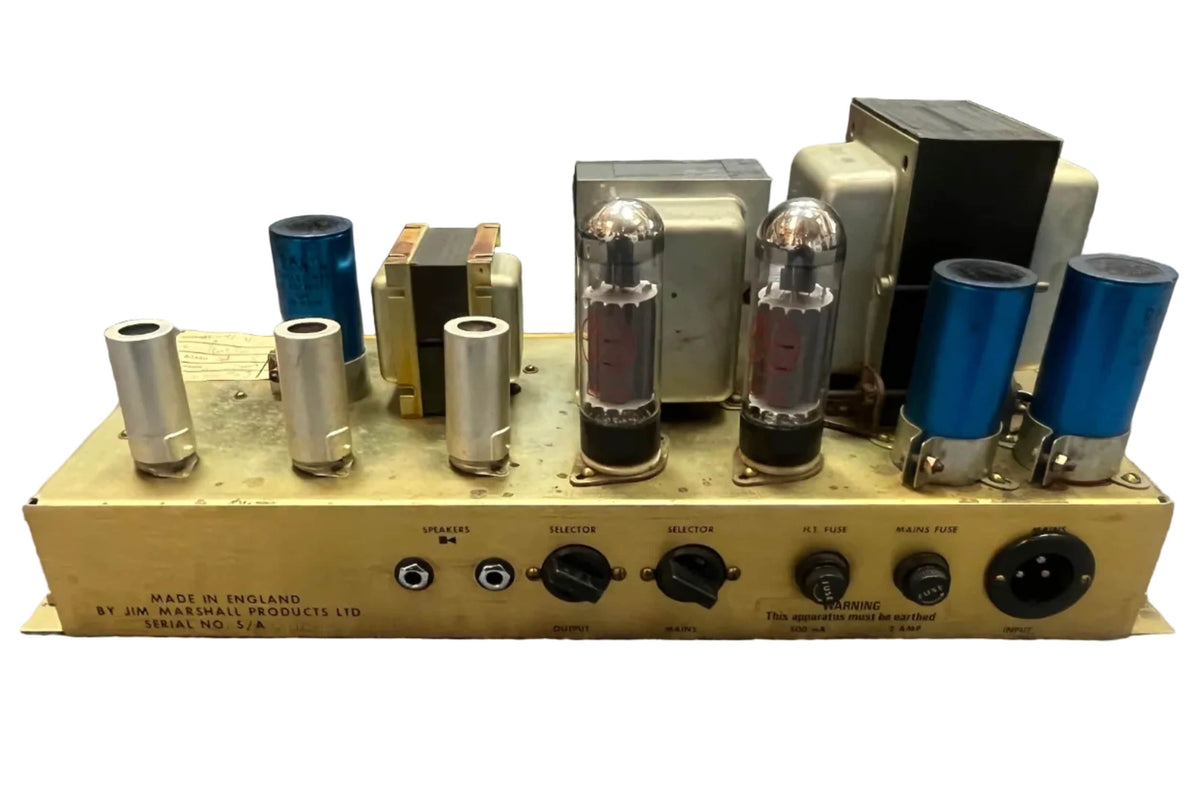 The 1971 Marshall Lead Head JMP 1987 50 Watt by Marshall includes a flight case and features classic vacuum tubes and jacks on a beige metal chassis—perfect for delivering legendary British tones.
