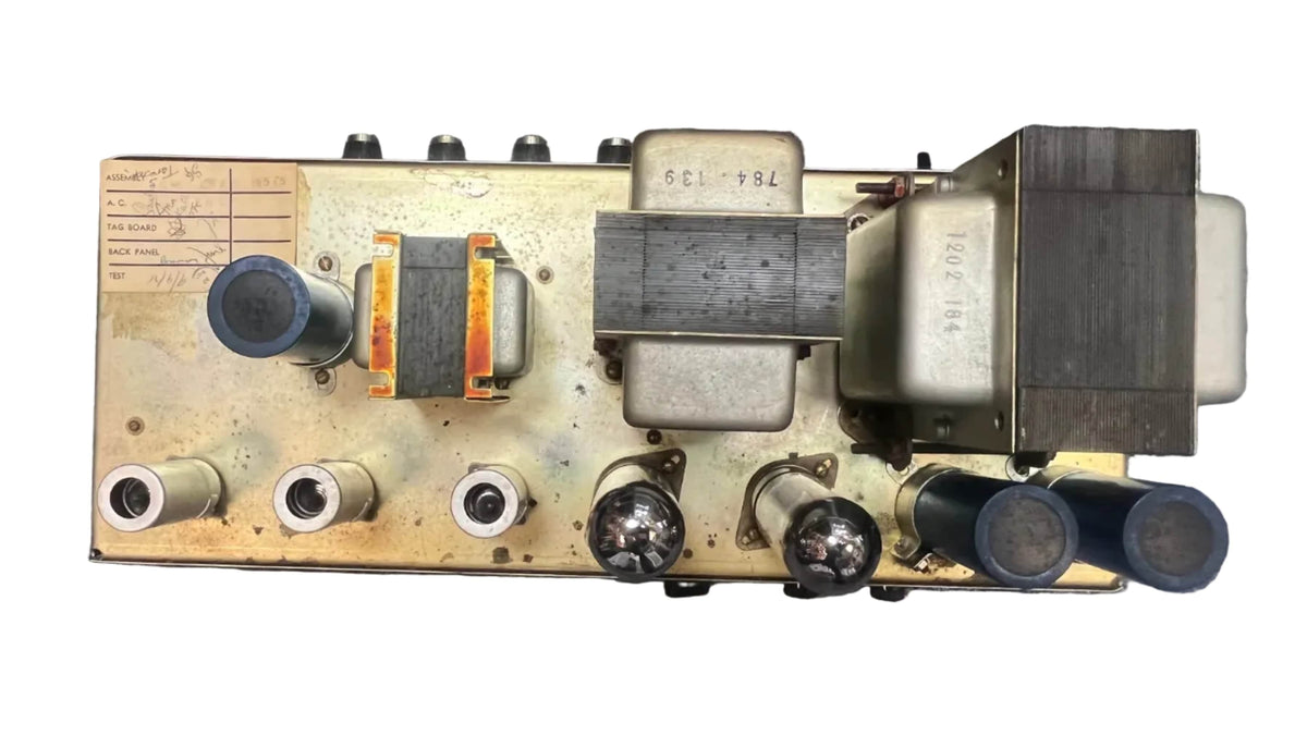 Top view of a Marshall 1971 Lead Head JMP 1987 50W, featuring vacuum tubes, transformers, capacitors, and labeled parts on a metal plate—classic British engineering. Includes flight case.