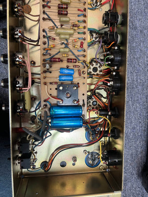 Interior of a vintage Marshall 1971 Lead Head JMP 1987 50W amp, showing circuit board with capacitors, resistors, wires, and jacks on metallic chassis—inspired by the iconic Marshall sound. Includes flight case.