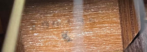 Close-up of the textured brown wood surface with faint black markings and a white streak, echoing the craftsmanship found on the Sigma Vintage DR-35 Acoustic Guitar w/case (Made in Japan).