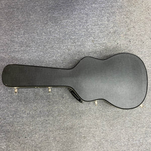 A Waterloo WL-12 Parlor Acoustic w/Case (Used, Consign) by Waterloo, featuring a black hard-shell case with metal latches, is closed and resting on a gray carpeted floor.